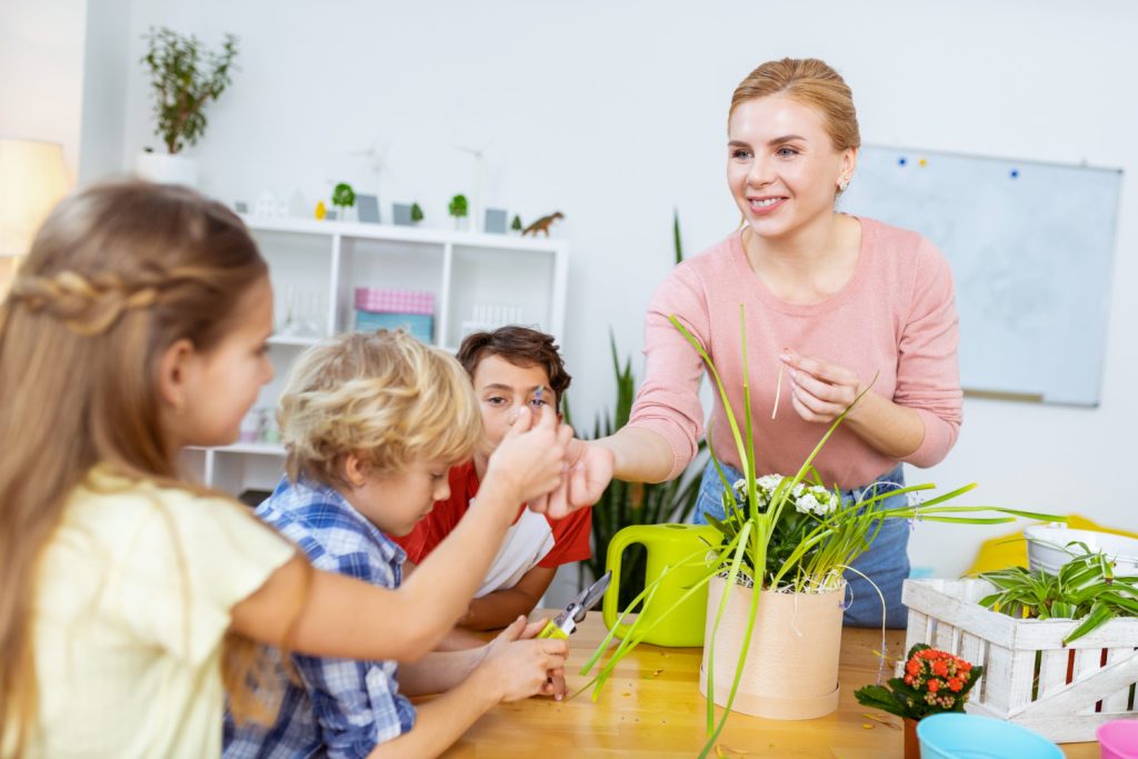 giving-little-flower-beaming-pleasant-ecology-teacher-smiling-while-giving-little-flower-cute-schoolgirl.jpg